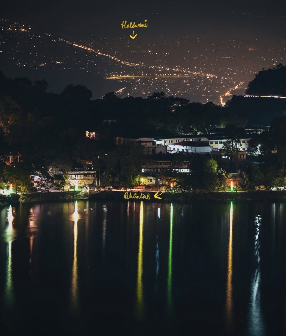 Bhimtal after dark, with the plains city of Haldwani glittering in the distance — the lake sits at the centre of an increasingly connected belt.